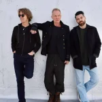Sting, Dominic Miller, and Chris Maas leaning against a white wall for a sting tour promotional photo.