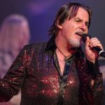 Tommy DeCarlo lead singer of Boston performing live on stage