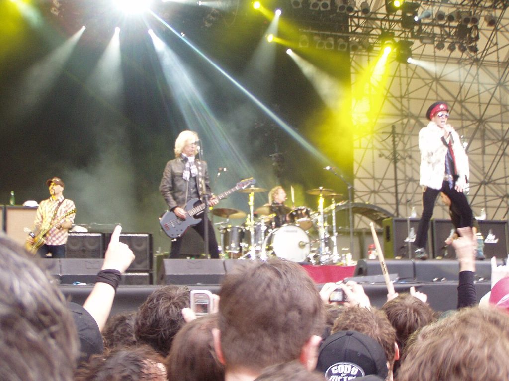 The legendary members of velvet revolver performing live on stage during their peak years.