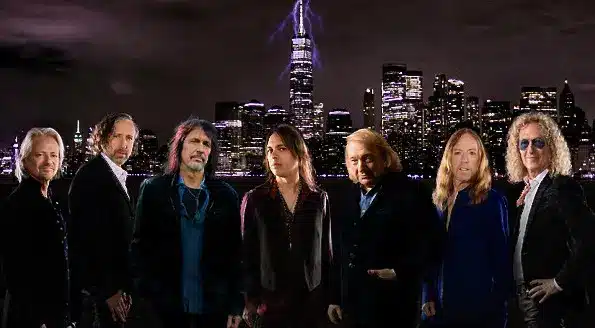 In The Eye Of The Storm: Foreigner New Album 1 In The Eye Of The Storm Foreigner band members posing against a dramatic New York City skyline promoting their upcoming album release.