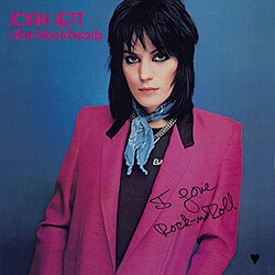 I Love Rock ’n Roll album cover by Joan Jett featuring her in a pink jacket against a blue background.