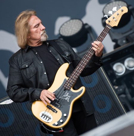 Geezer Butler Black Sabbath bassist performing live on stage