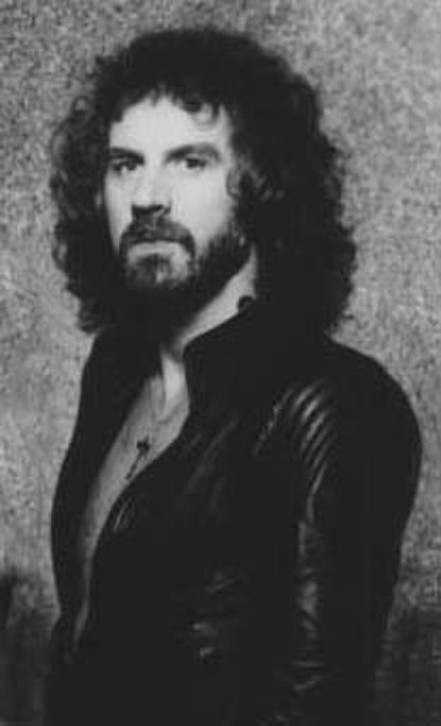 Geoff Nicholls portrait in black and white wearing a leather jacket.