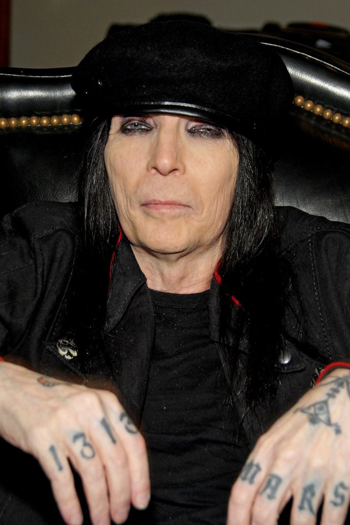 Mick Mars playing guitar live on stage, lead guitarist and co-founder of Mötley Crüe
