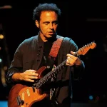 Nils Lofgren performing live on guitar with the E Street Band