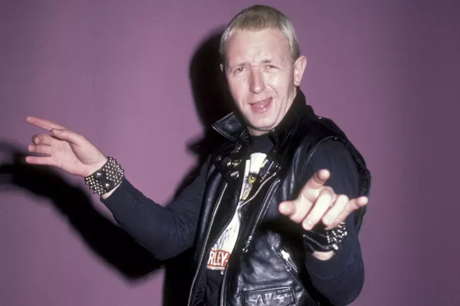 Rob Halford performing live with Judas Priest, leather-clad metal god on stage