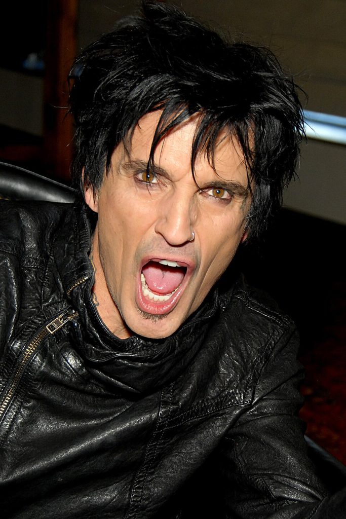 Tommy Lee playing drums live on stage, co-founder and drummer of Mötley Crüe