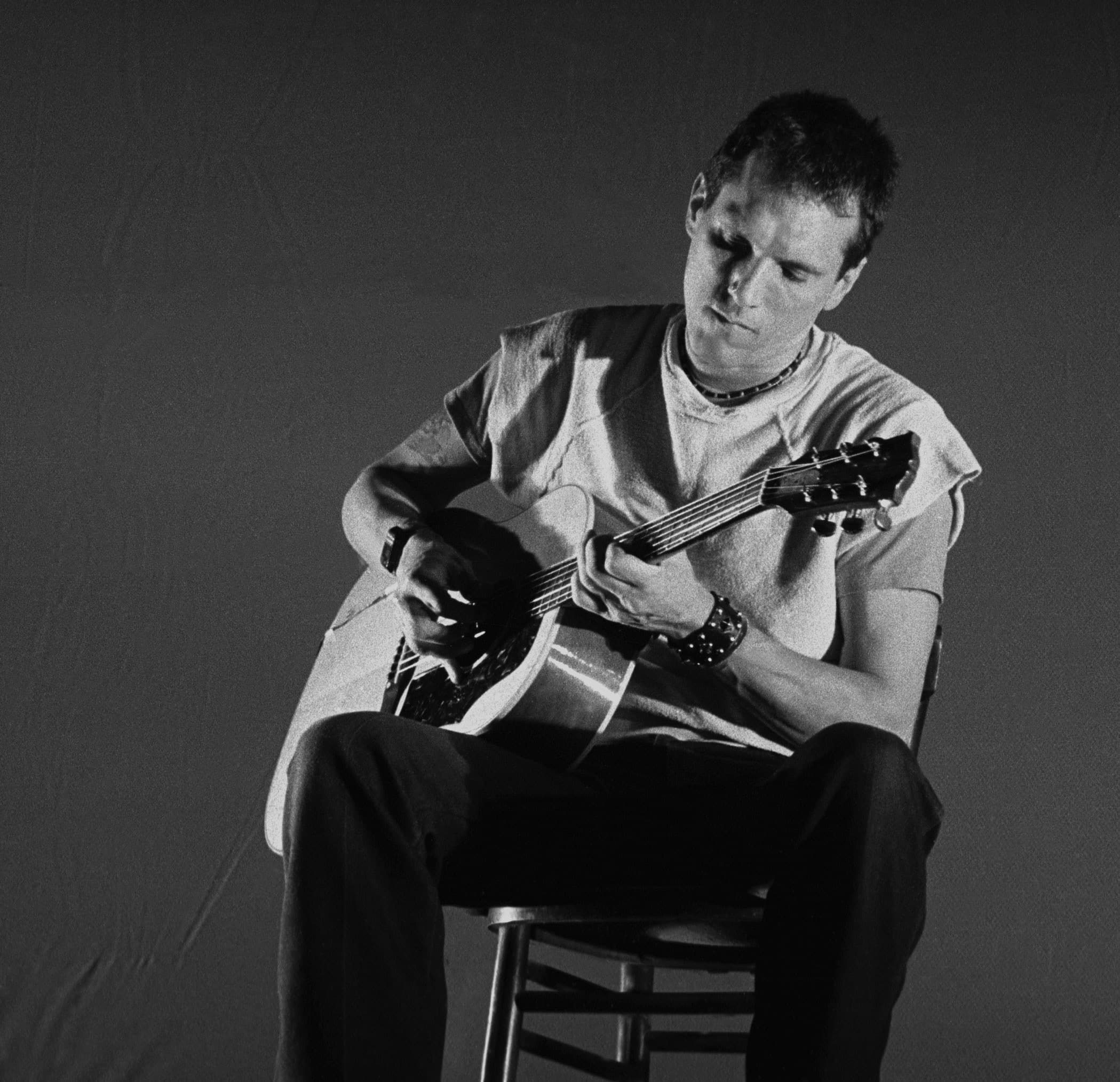 Jorma Kaukonen seated with an acoustic guitar in 1984