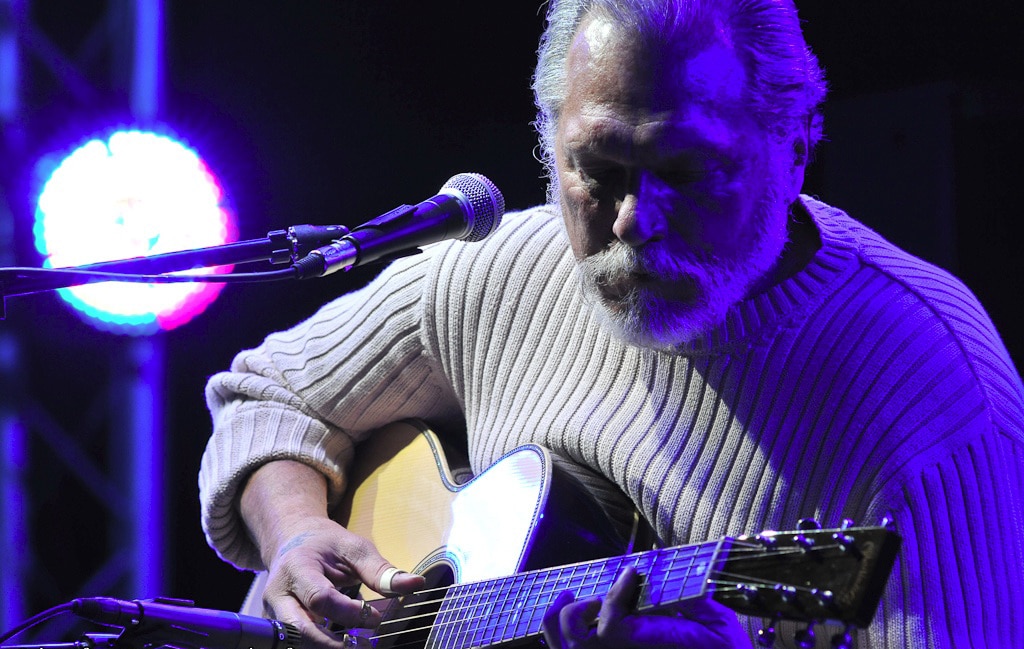 Jorma Kaukonen playing acoustic guitar on stage in 2009