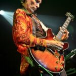 steve vai performing live on stage in 2022